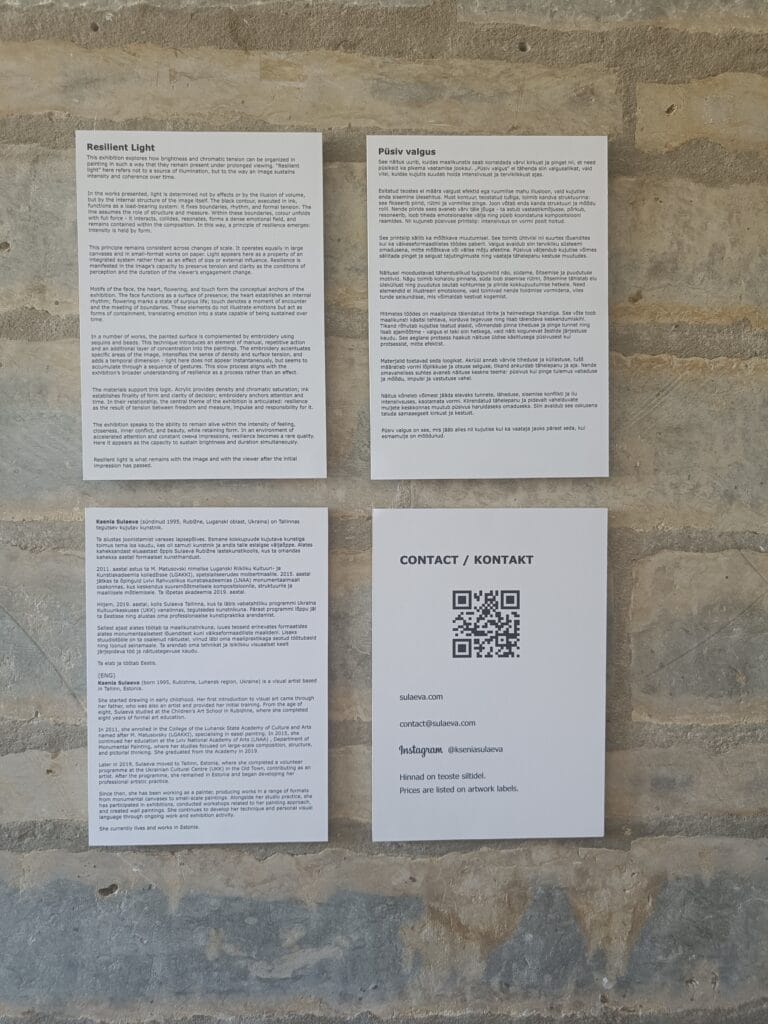 Exhibition information panels mounted on a stone wall, featuring details about artist Ksenia Sulaeva and her exhibition "Resilient Light" in both Estonian and English, alongside contact information and a QR code.